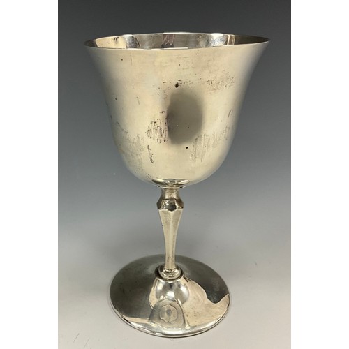 244 - An Edwardian silver wine cup, flared rim, the bowl quite plain, faceted column, spreading circular b... 