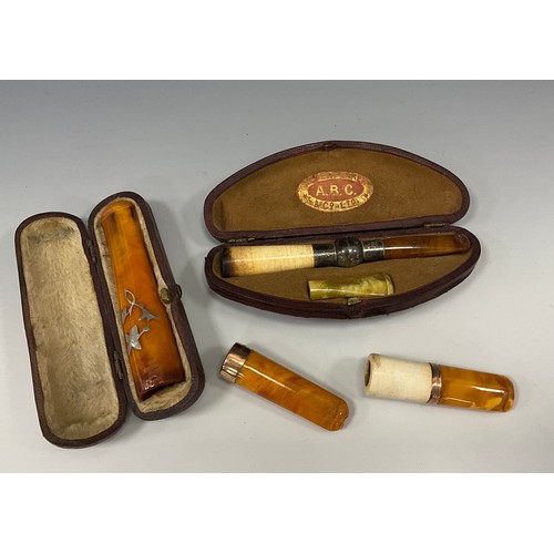 1863 - A Victorian 9ct rose gold mounted cigar or cigarette holder, 5cm long, Birmingham 1860; another simi... 