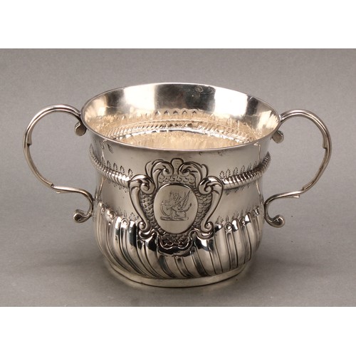 160 - A Queen Anne Britannia silver half-fluted porringer, scroll handles, rope-twist quarter girdle, 17.5... 