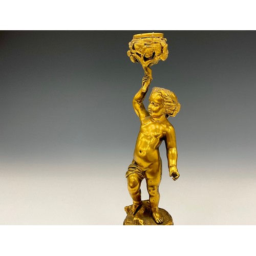 1846 - A pair of 19th century gilt metal figural candlesticks, each cast as a scantily clad putto, 26cm hig... 