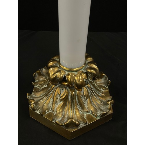 2000 - A 19th century gilt metal oil lamp, opaque milk glass column, fitted on acanthus scroll on hexagonal... 