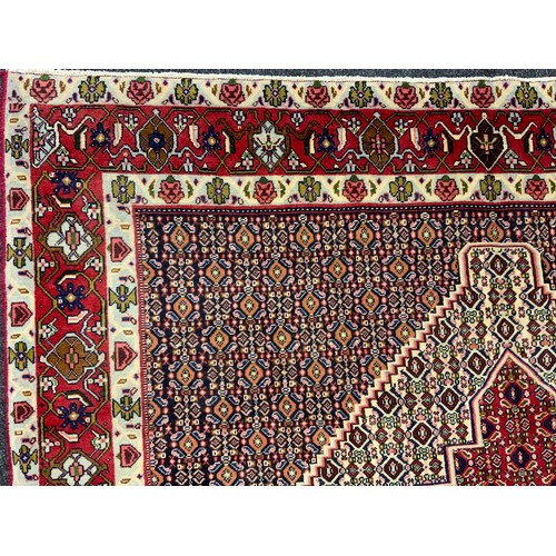 2061 - A North West Persian Senneh carpet, knotted with concentric hexagonal form medallions within a patte... 