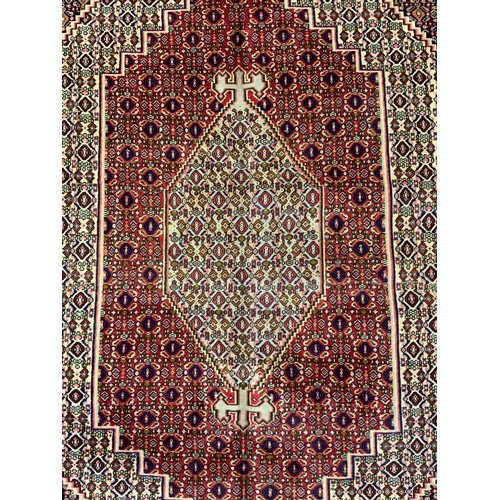 2061 - A North West Persian Senneh carpet, knotted with concentric hexagonal form medallions within a patte... 