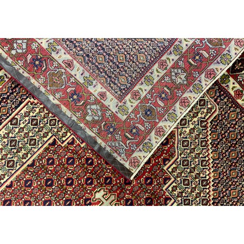 2061 - A North West Persian Senneh carpet, knotted with concentric hexagonal form medallions within a patte... 