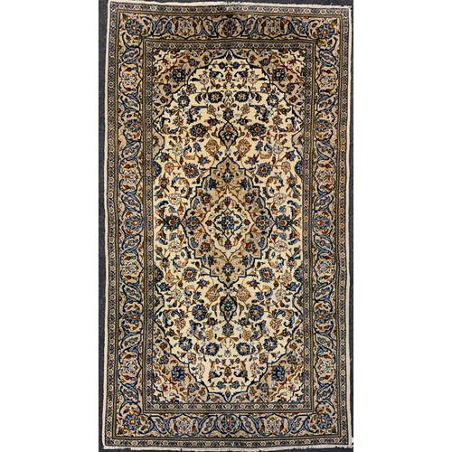 2055 - A Central Persian Kashan carpet, central Navette-shaped medallion within a field of stylised scrolli... 