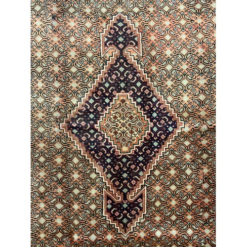 2067 - A Bijar wool and silk mix rug, the diamond shaped medallion within a densely patterned field, in ton... 