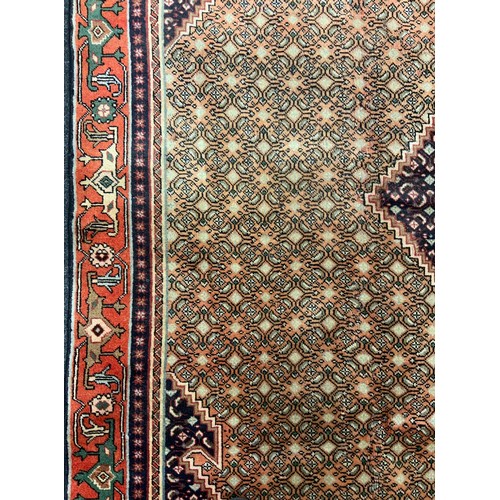 2067 - A Bijar wool and silk mix rug, the diamond shaped medallion within a densely patterned field, in ton... 