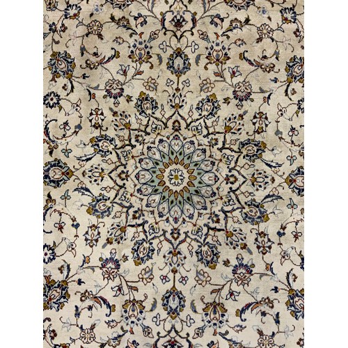 2070 - A Kashan rug, knotted with a central lotus-form medallion within a field of stylised scrolling flora... 