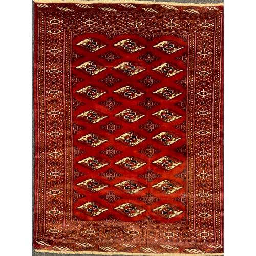 2073 - A Turkman rug, typical repeating Göl pattern, in rich tones of red, with white and black accents, 17... 