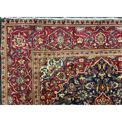 2069 - A Kashan rug, knotted with a central Nanette-shaped medallion within a densely woven field of stylis... 