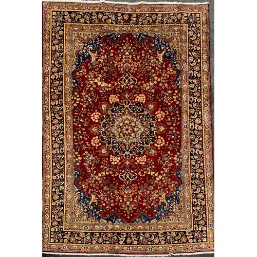 2072 - A Tabriz rug, central lotus-form medallion within a field of stylised floral motifs, in rich tones o... 