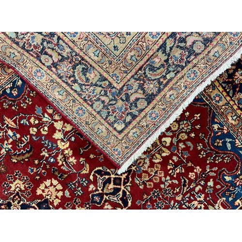 2072 - A Tabriz rug, central lotus-form medallion within a field of stylised floral motifs, in rich tones o... 