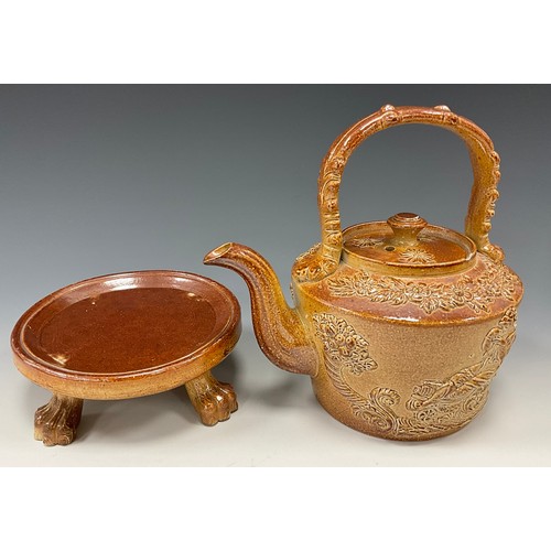 1176 - A 19th century Brampton salt glazed stoneware tea kettle and cover on stand, stiff leaf carrying han... 