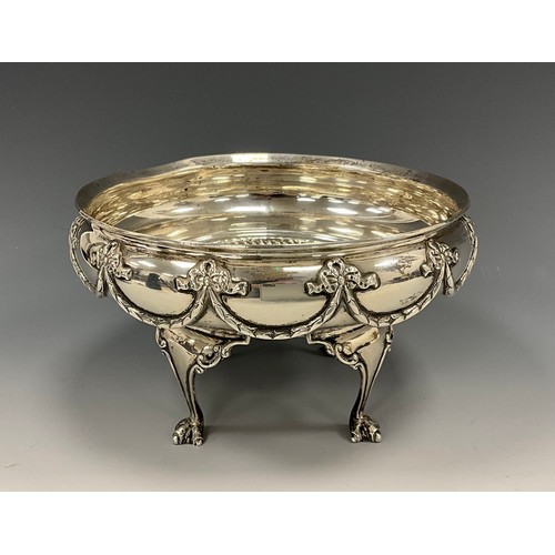 219 - A George V silver bowl, cast with tied ribbons, bows and swags, raised on four clawed feet, 16.7cm d... 