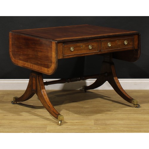 2128 - A Post-Regency tulipwood crossbanded mahogany sofa table, rounded rectangular top with channelled ed... 