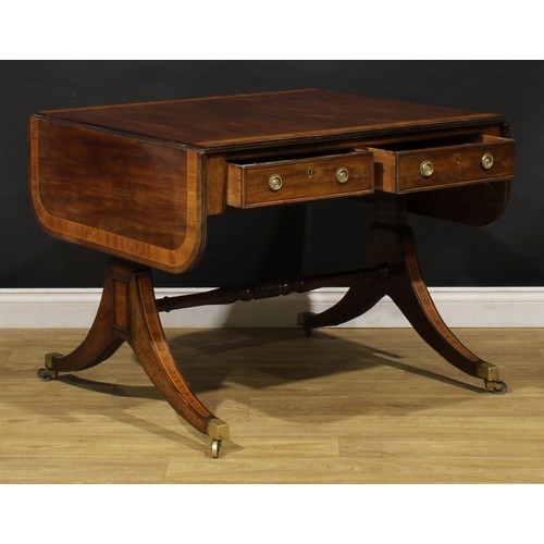 2128 - A Post-Regency tulipwood crossbanded mahogany sofa table, rounded rectangular top with channelled ed... 