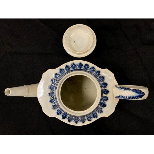 1205 - A Hawley blue and white pearlware teapot, in the commode shape, moulded in relief with linen swags a... 