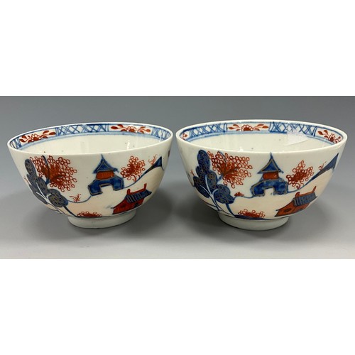 1223 - A pair of Lowestoft tea bowls, painted in the Imari palette with chinoiserie landscapes, 19cm diamet... 