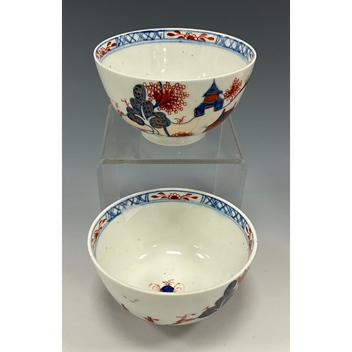 1223 - A pair of Lowestoft tea bowls, painted in the Imari palette with chinoiserie landscapes, 19cm diamet... 