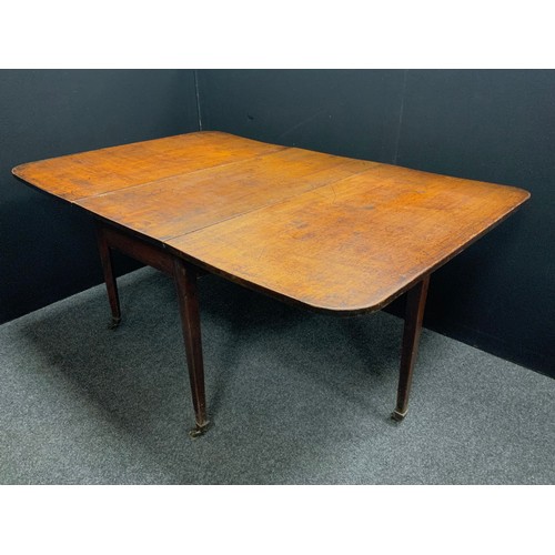 1604 - A George III mahogany drop leaf dining table, brass casters, 73.5cm high, 162cm wide extended, 107cm... 