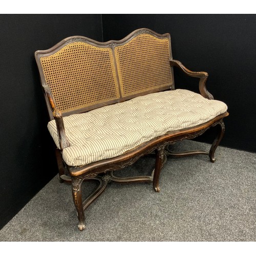 1642 - An early Victorian carved walnut loving seat or settle, bergere weave double serpentine shaped back,... 