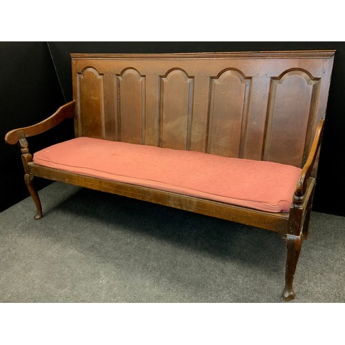 1916 - An 18th century oak settle, rectangular back with five arched raised and fielded panels, turned arm ... 