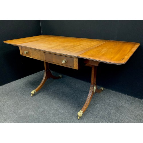 1641 - A Regency mahogany sofa table, the rounded rectangular drop-leaf top with a pair of drawers to each ... 