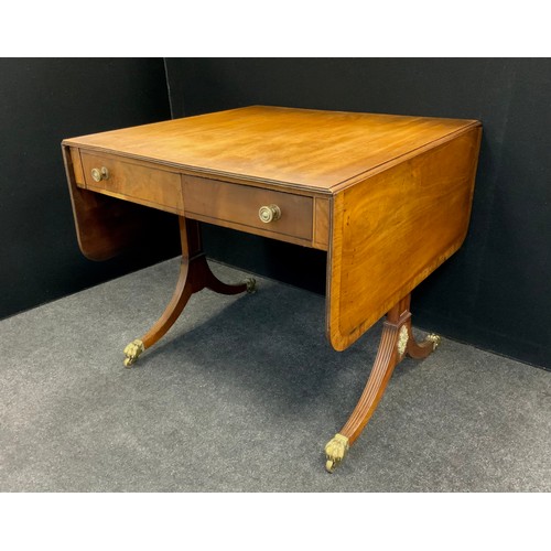 1641 - A Regency mahogany sofa table, the rounded rectangular drop-leaf top with a pair of drawers to each ... 