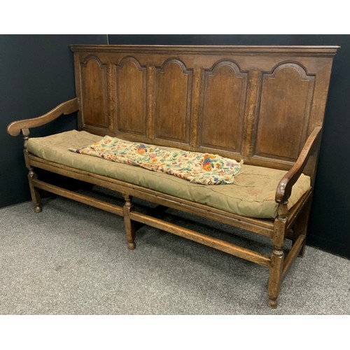 1917 - An 18th century oak settle, rectangular five panel back, down swept arms, turned arm posts, rectangu... 