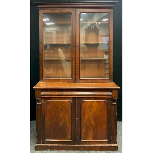 1698 - A Victorian mahogany library bookcase, outswept cornice above a pair of glazed doors enclosing adjus... 