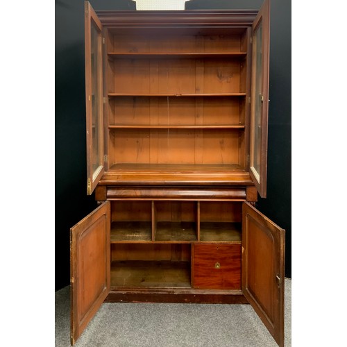 1698 - A Victorian mahogany library bookcase, outswept cornice above a pair of glazed doors enclosing adjus... 