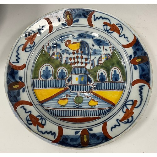 1254 - 18th century Delftware ware including a Dutch Delft polychrome plate, painted with a garden scene an... 