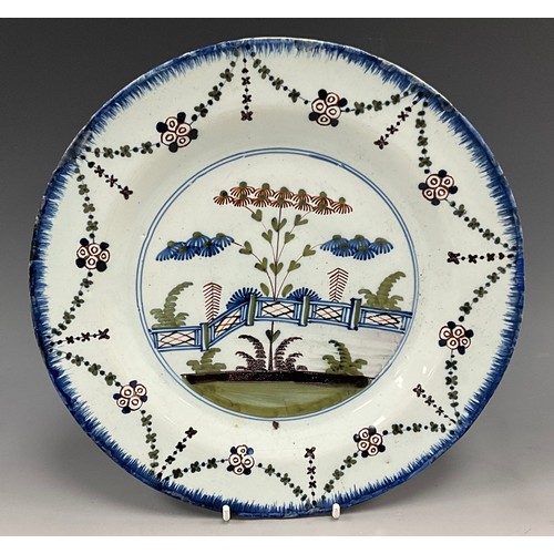 1254 - 18th century Delftware ware including a Dutch Delft polychrome plate, painted with a garden scene an... 