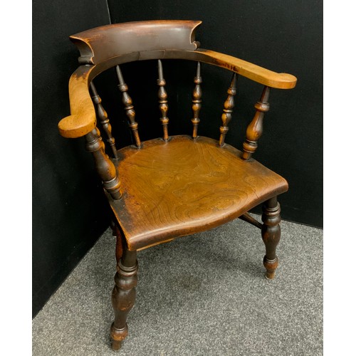 1616 - A Victorian beech and elm smoker’s bow elbow chair, of good colour and figure, unusual saddle-shaped... 