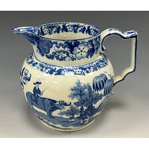 1187 - A 19th century pearlware blue and white transfer-printed pitcher, decorated with a Boy on a Buffalo,... 