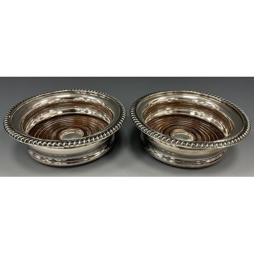 379 - A pair of Elizabeth II silver and mahogany wine coasters, 14.5cm diameter, Birmingham 1969, 13.4ozt ... 