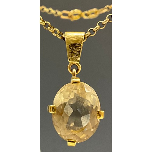 634 - A pale yellow topaz or citrine oval pendant necklace, approx 15mm x 12mm x 9mm, unmarked yellow meta... 