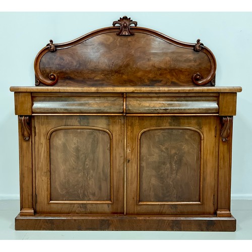 1577 - An early Victorian mahogany chiffonier, shaped quarter galleried back, with carved crest, and C-scro... 