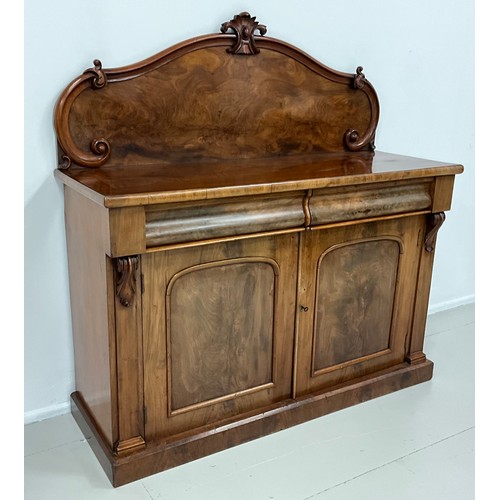 1577 - An early Victorian mahogany chiffonier, shaped quarter galleried back, with carved crest, and C-scro... 