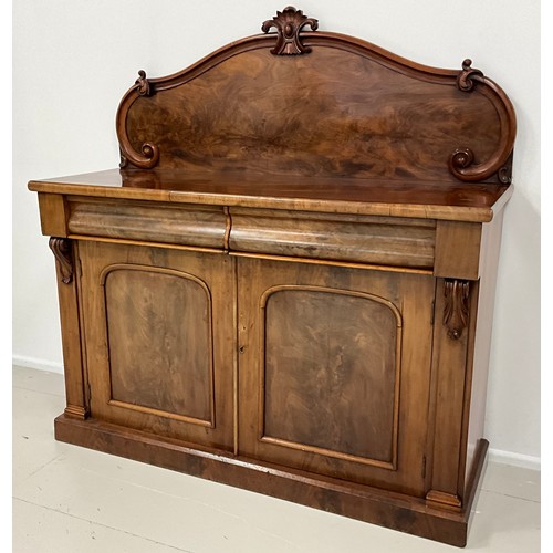 1577 - An early Victorian mahogany chiffonier, shaped quarter galleried back, with carved crest, and C-scro... 