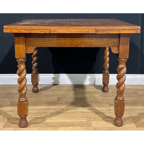 107 - An early 20th century oak draw-leaf dining table, c.1935