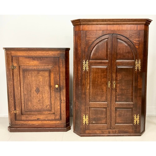 1906 - A Georgian crossbanded oak and mahogany corner cabinet, two arched panel doors, fitted interior with... 