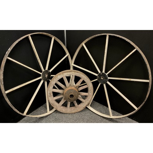 2147 - A large pair of 19th century wrought iron cart wheels 107cm diameter;  and another, smaller wooden c... 