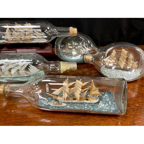 2153 - Maritime Interest - early 20th century hand crafted ships in bottles including a four masted steel b... 