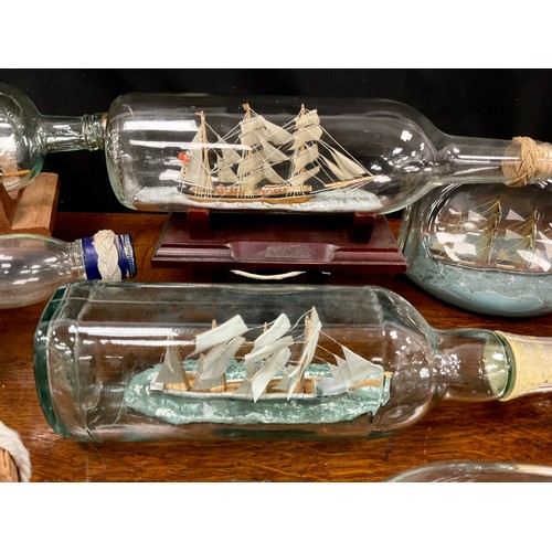 2153 - Maritime Interest - early 20th century hand crafted ships in bottles including a four masted steel b... 