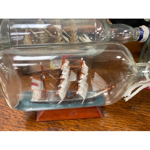 2153 - Maritime Interest - early 20th century hand crafted ships in bottles including a four masted steel b... 