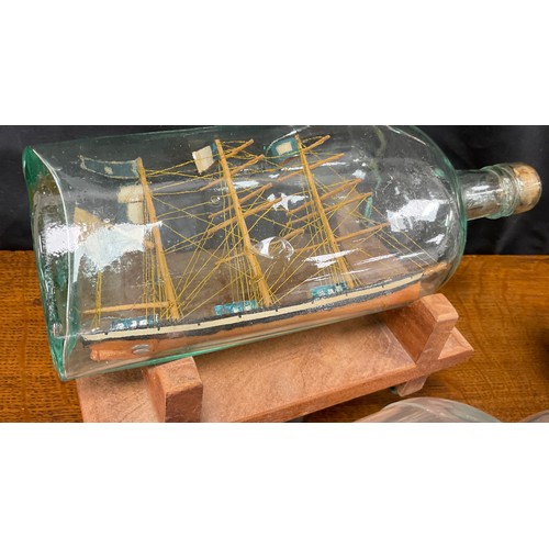 2153 - Maritime Interest - early 20th century hand crafted ships in bottles including a four masted steel b... 