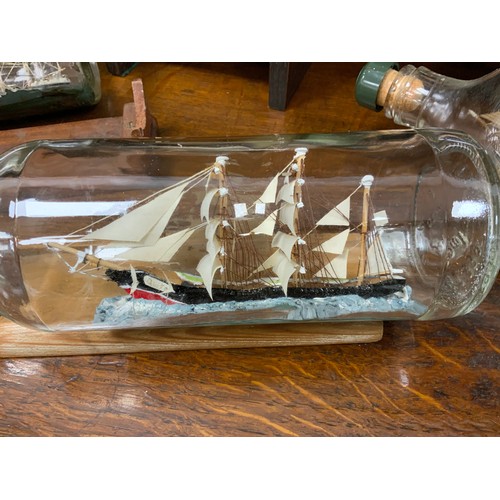 2155 - Maritime Interest - early 20th century hand crafted ships in bottles including Quito, 30cm long; oth... 