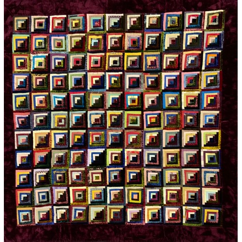 2095 - A 20th century log cabin quilt, with vibrant coloured square blocks, sunshine and shadow shading, to... 