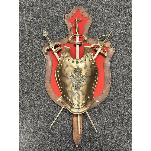 629 - A large wall mounted decorative display of a reproduction breast plate with three crossed swords. Si... 